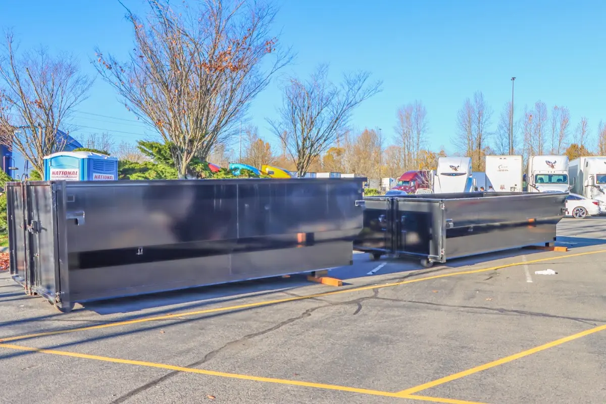 Professional dumpster rental service with roll-off container on residential driveway in Hewitt
